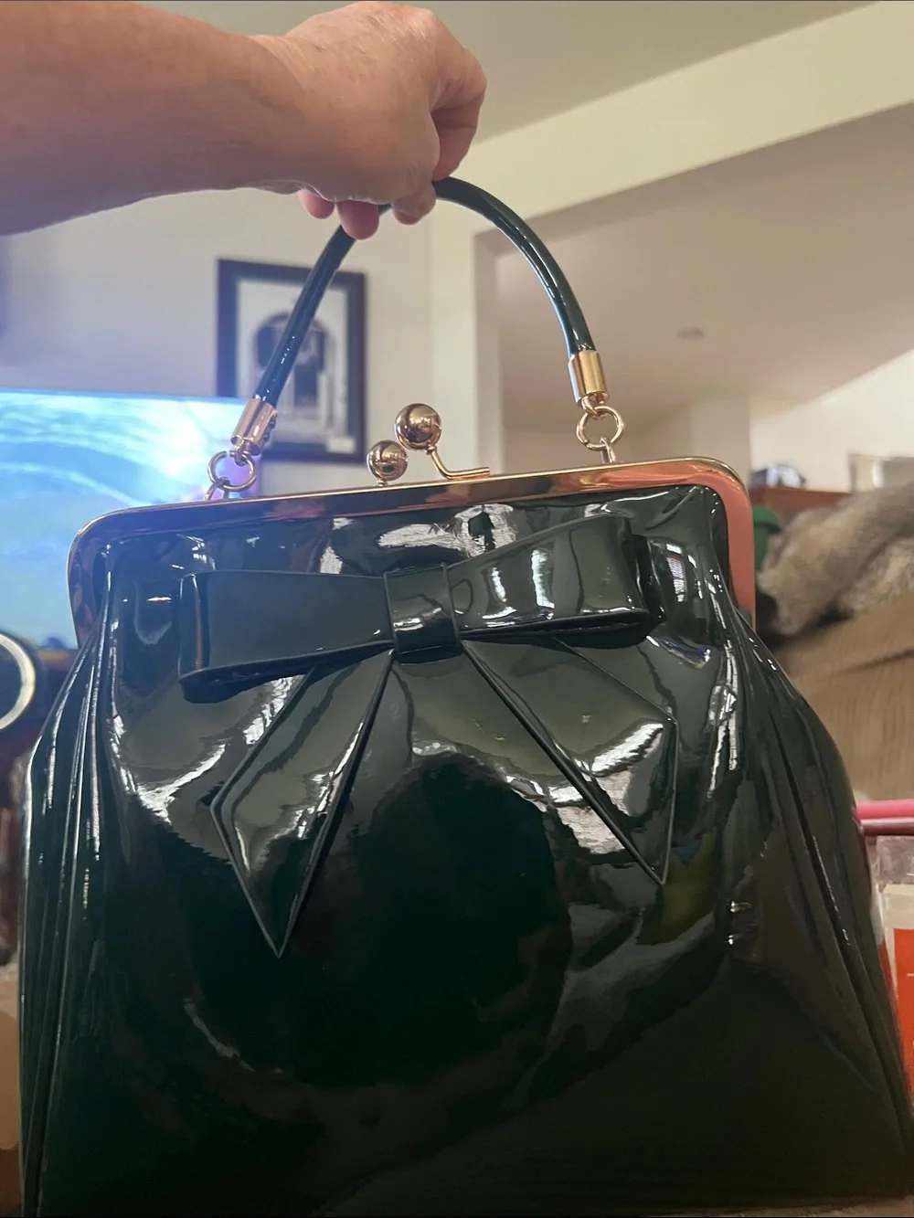 Last Queen black handbag features a patent vinyl finish